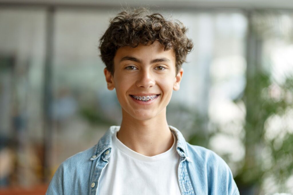 A teenage boy wearing braces